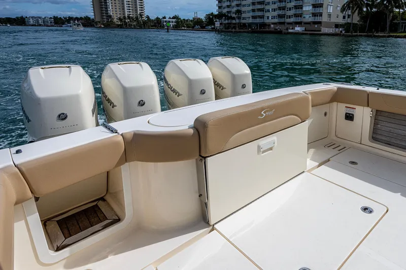 Slide: The Image of 2019 Scout 420 LXF boat with four outboard engines on a calm waterway. - 13