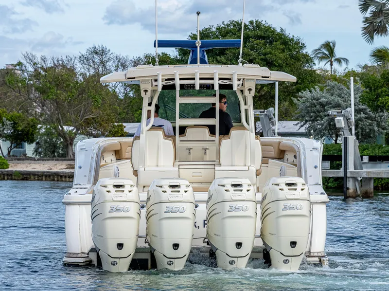 Slide: The Image of 2019 Scout 420 LXF boat with four powerful engines cruising on water. - 18