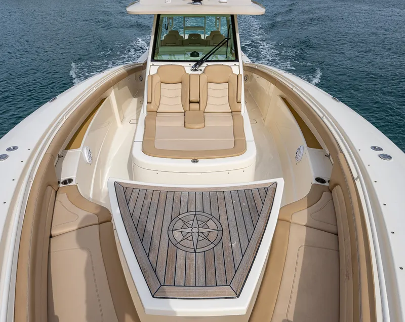 Slide: The Image of 2019 Scout 420 LXF boat with luxurious seating and teak deck on open water. - 5