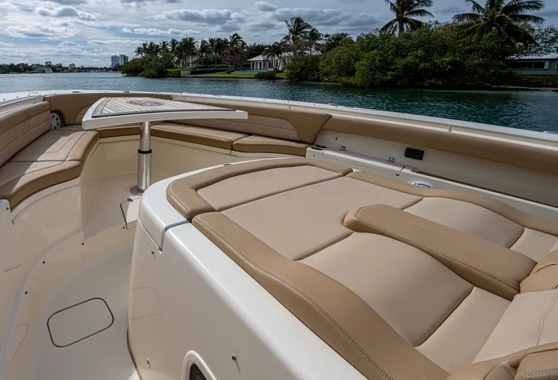 Slide: The Image of 2019 Scout 420 LXF boat interior with luxurious seating and scenic water view. - 7