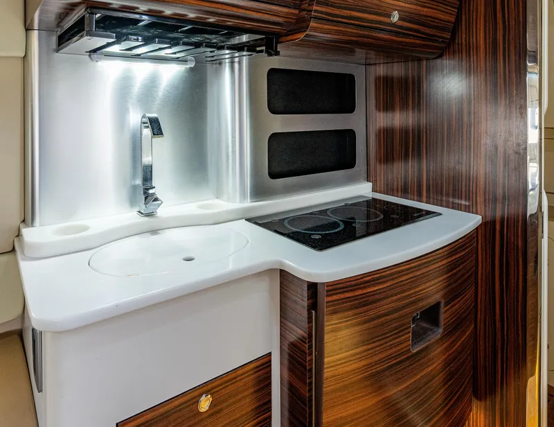 Slide: The Image of 2019 Scout 420 LXF yacht interior kitchen with modern sink and stovetop. - 9