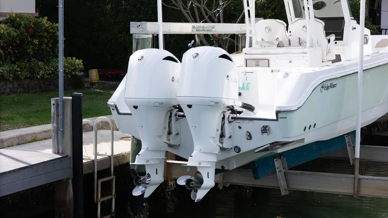 Slide: The Image of Edgewater 320CC 2019 boat with dual outboard engines docked at marina. - 18