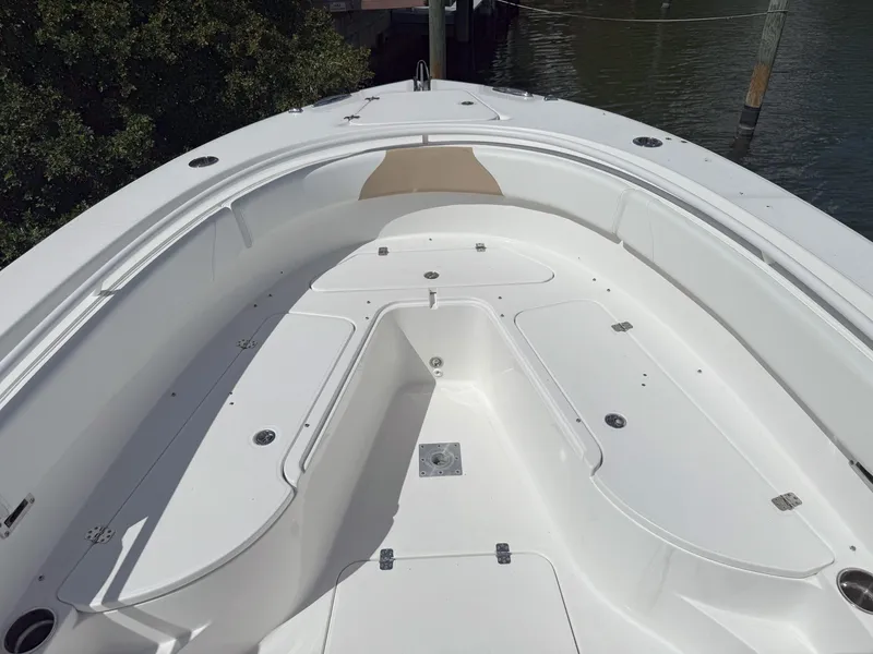 Slide: The Image of 2019 Edgewater 320CC boat deck, spacious and clean, with storage compartments. - 23