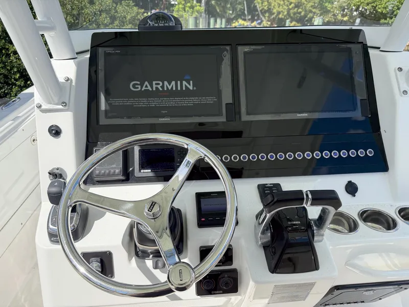 Slide: The Image of Edgewater 320CC 2019 boat dashboard with Garmin navigation system and steering wheel. - 25