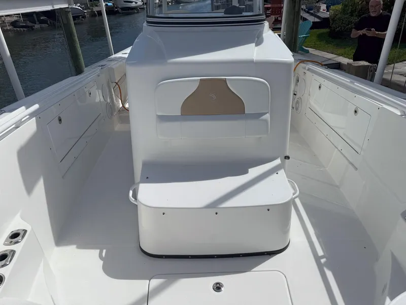 Slide: The Image of 2019 Edgewater 320CC boat interior, featuring spacious deck and seating area. - 29