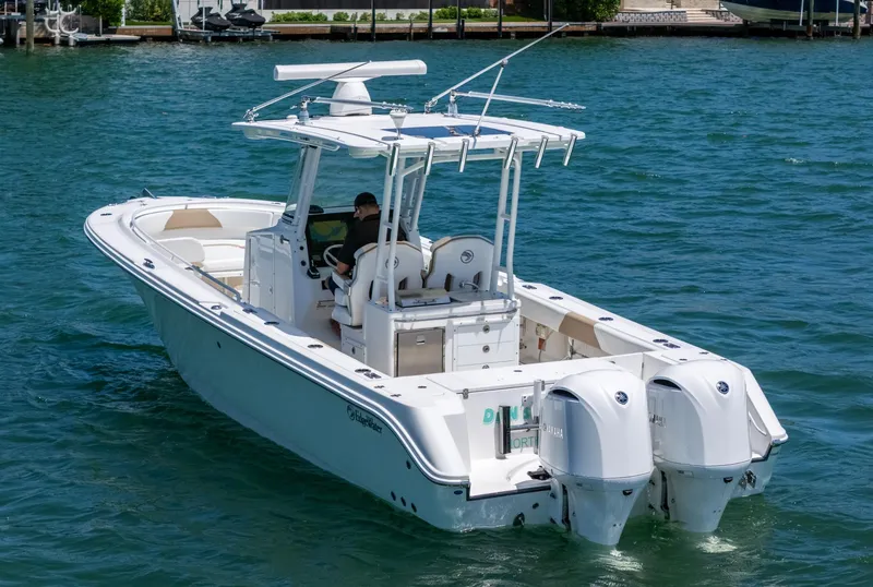 Slide: The Image of 2019 Edgewater 320CC boat on water, featuring dual outboard engines. - 3