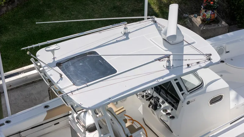 Slide: The Image of 2019 Edgewater 320CC boat, aerial view of helm and T-top design. - 31