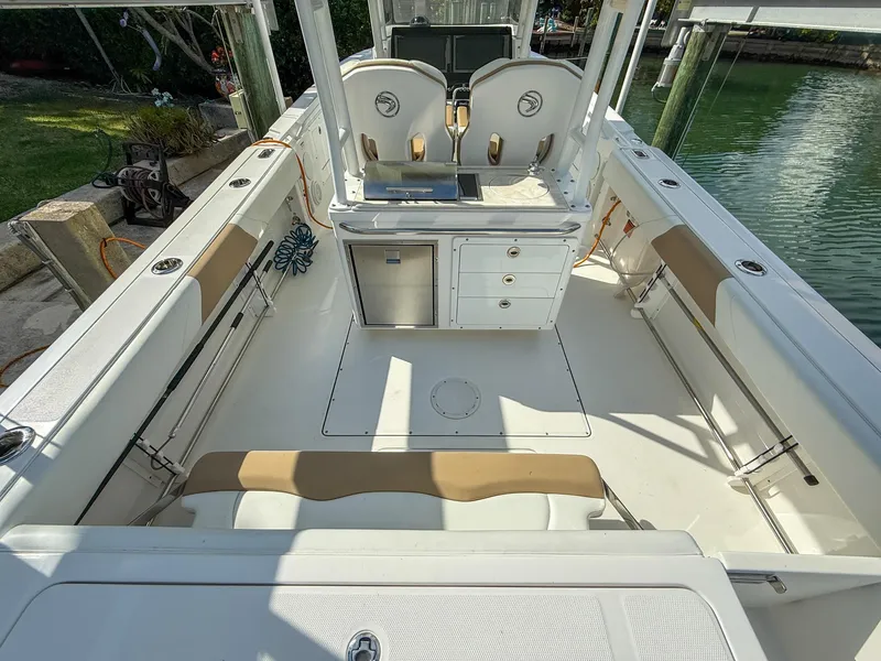 Slide: The Image of 2019 Edgewater 320CC boat interior with seating, storage, and helm station. - 38