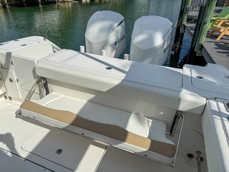 Slide: The Image of 2019 Edgewater 320CC boat with foldable seating and dual Yamaha outboard engines. - 40