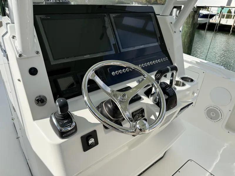 Slide: The Image of 2019 Edgewater 320CC boat helm with dual screens and modern controls. - 44