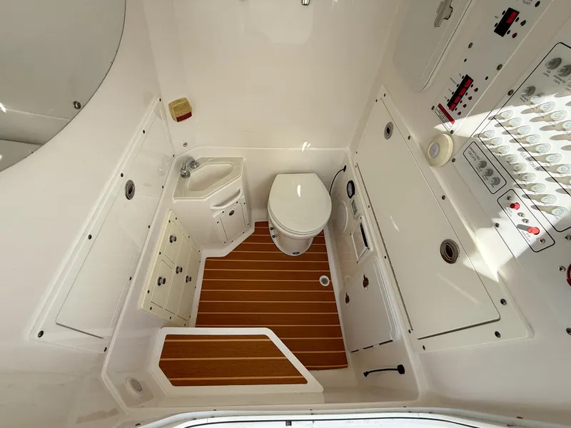 Slide: The Image of 2019 Edgewater 320CC boat bathroom with wooden flooring and modern fixtures. - 48