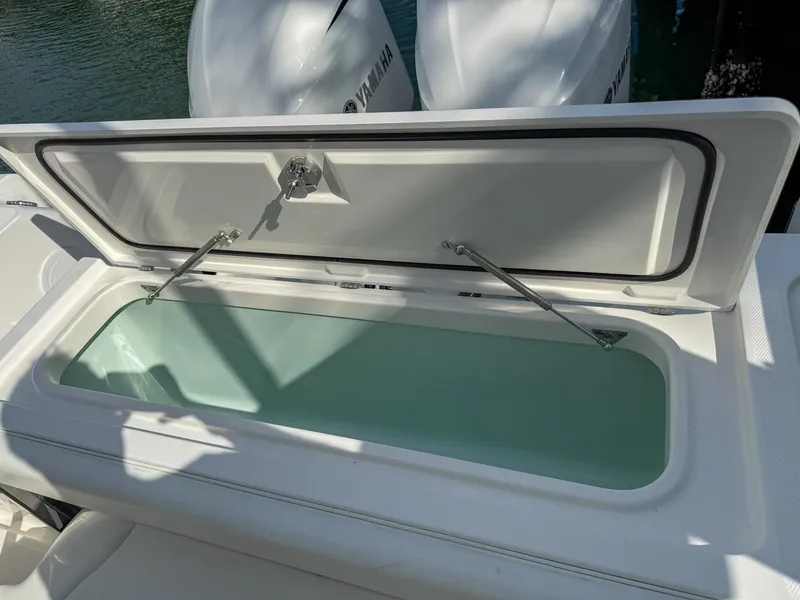 Slide: The Image of Open storage compartment on 2019 Edgewater 320CC boat with Yamaha engines. - 55