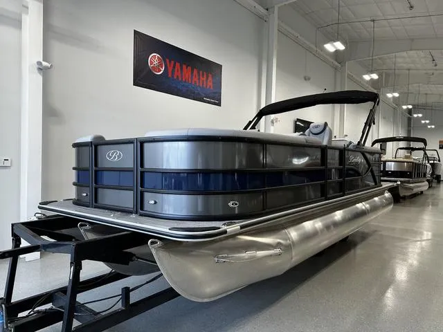 Slide: The Image of 2025 Bentley Pontoons 223 NAVIGATOR in showroom, sleek design, Yamaha banner in background. - 1