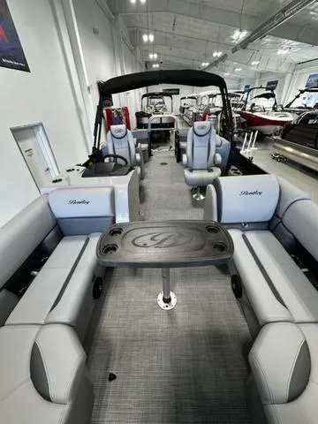 Slide: The Image of 2025 Bentley Pontoons 223 NAVIGATOR interior with luxurious seating and table setup. - 5