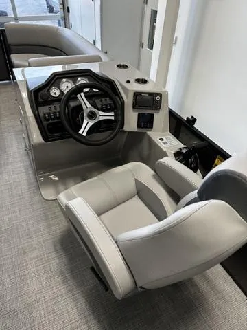 Slide: The Image of 2025 Bentley Pontoons 223 NAVIGATOR interior with modern steering console and comfortable seating. - 6