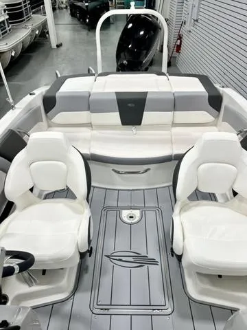 Slide: The Image of 2024 Chaparral 19 SSi OB boat interior with white seating and sleek design. - 8