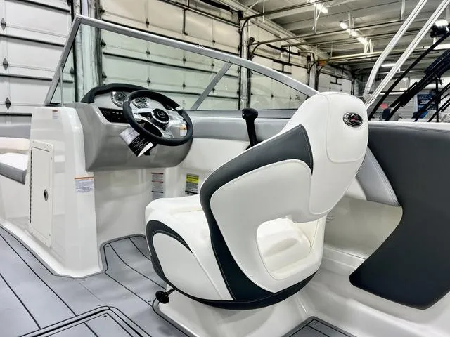 Slide: The Image of 2024 Chaparral 19 SSi OB boat interior with steering wheel and seating. - 9