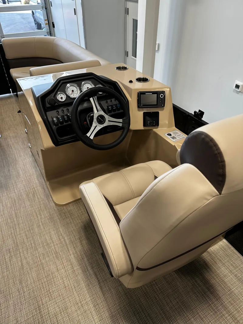 Slide: The Image of 2025 Bentley Pontoons 223 NAVIGATOR interior with steering console and beige seating. - 10