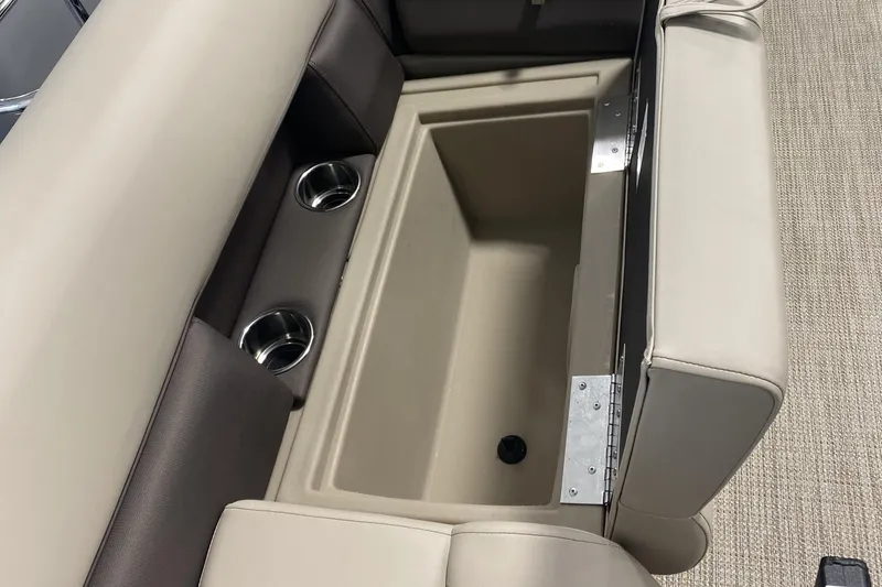 Slide: The Image of 2025 Bentley Pontoons 223 NAVIGATOR storage compartment with cup holders and beige seating. - 14