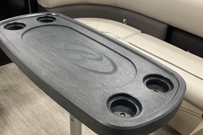 Slide: The Image of 2025 Bentley Pontoons 223 NAVIGATOR table with cup holders, featuring sleek design and comfortable seating. - 16