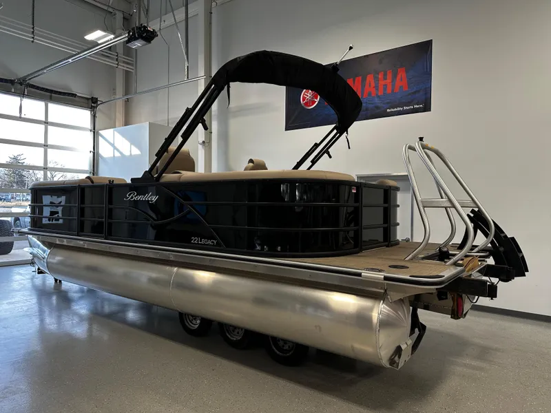 Slide: The Image of 2025 Bentley Pontoons 223 NAVIGATOR in showroom, featuring sleek design and Yamaha banner. - 3