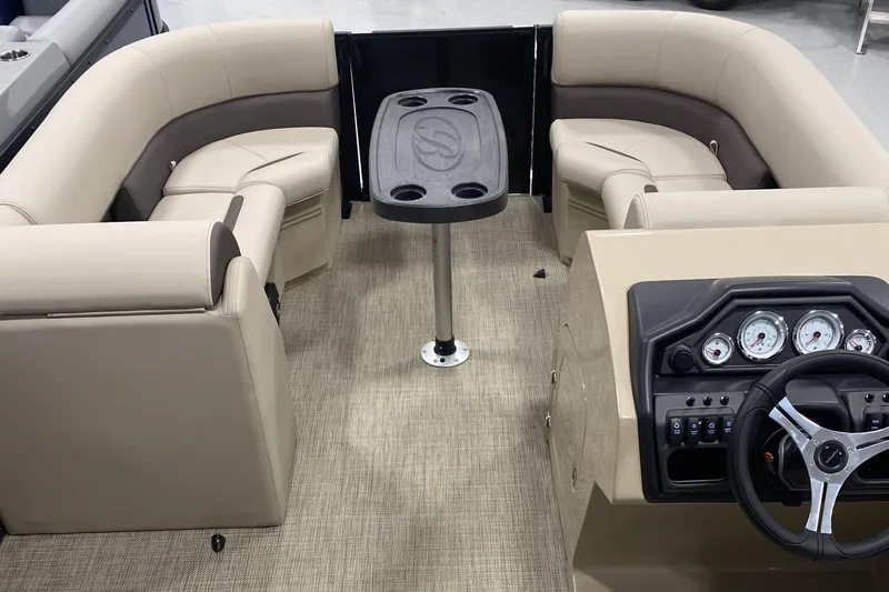 Slide: The Image of 2025 Bentley Pontoons 223 NAVIGATOR interior with beige seating and steering console. - 6