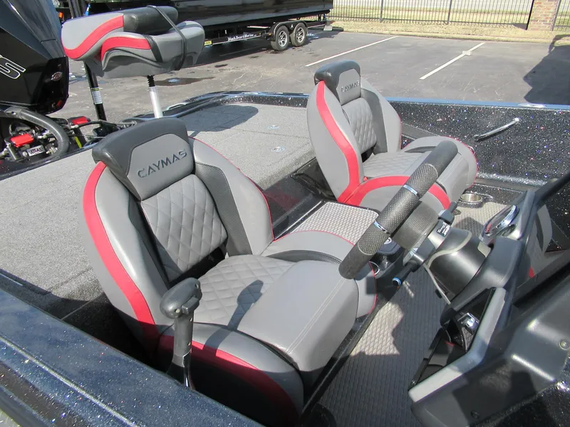 Slide: The Image of 2024 Caymas CX 20 boat interior with gray and red seating, steering wheel, and console. - 3