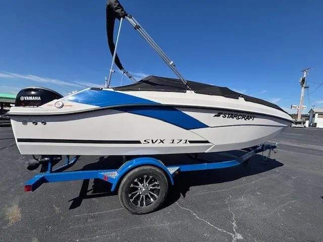 Slide: The Image of 2024 Starcraft SVX 171 boat on blue trailer, featuring sleek design and Yamaha engine. - 5