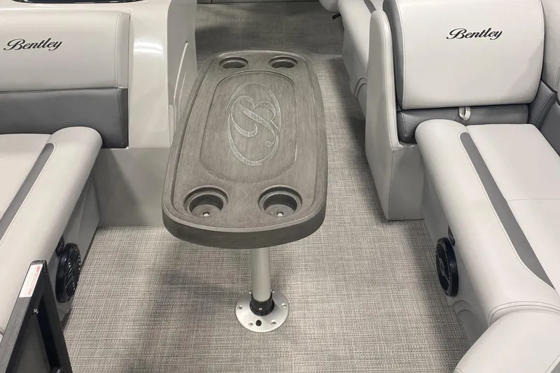 Slide: The Image of 2025 Bentley Pontoons 223 Swingback interior with gray seating and central table. - 12