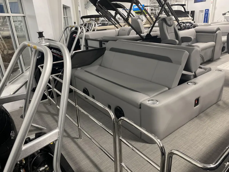 Slide: The Image of 2025 Bentley Pontoons 223 Swingback with sleek seating and modern design in a showroom. - 3