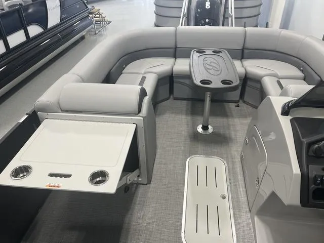 Slide: The Image of 2025 Bentley Pontoons 223 Swingback interior with gray seating and table. - 5