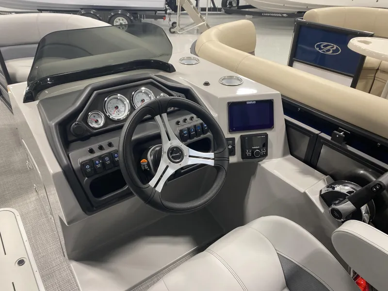 Slide: The Image of 2025 Bentley Pontoons 223 Swingback dashboard with steering wheel and control panel. - 7