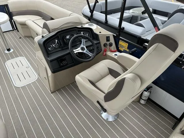 Slide: The Image of 2024 Bentley Pontoons Legacy 243 Navigator interior with captain's chair and dashboard. - 5