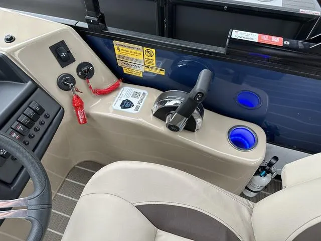 Slide: The Image of 2024 Bentley Pontoons Legacy 243 Navigator helm with controls and cup holders. - 6