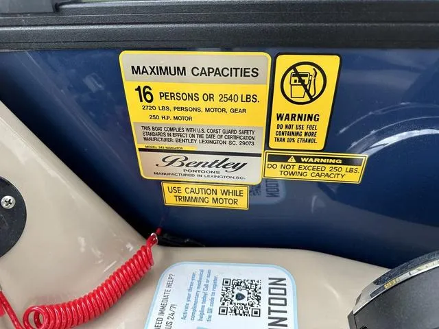 Slide: The Image of 2024 Bentley Pontoons Legacy 243 Navigator capacity and safety warning labels. - 7