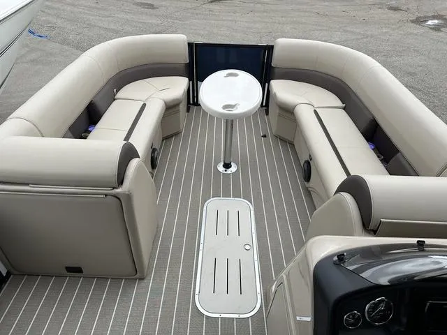 Slide: The Image of 2024 Bentley Pontoons Legacy 243 Navigator interior with beige seating and central table. - 8