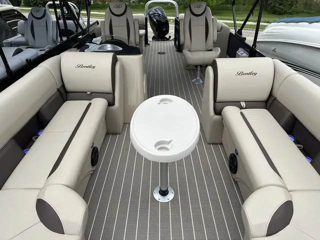 Slide: The Image of 2024 Bentley Pontoons Legacy 243 Navigator interior with luxurious seating and table. - 9