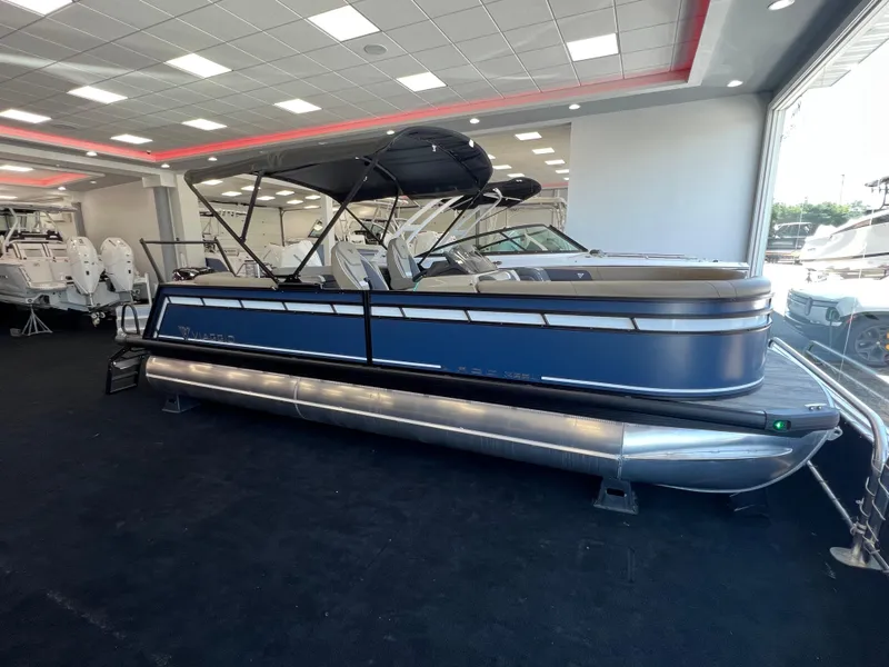 Slide: The Image of 2025 Viaggio Lago X-U pontoon boat displayed in a showroom. - 2