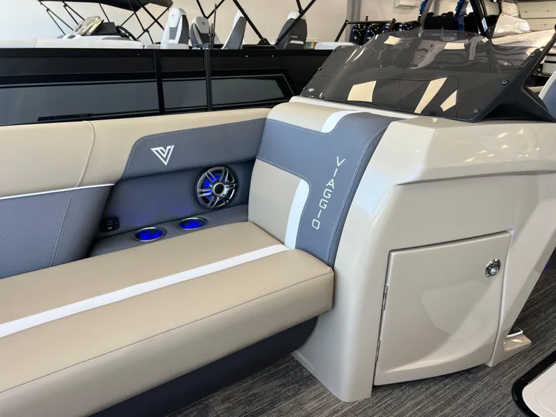 Slide: The Image of 2025 Viaggio Lago X-U boat interior with beige seating and blue LED cup holders. - 33