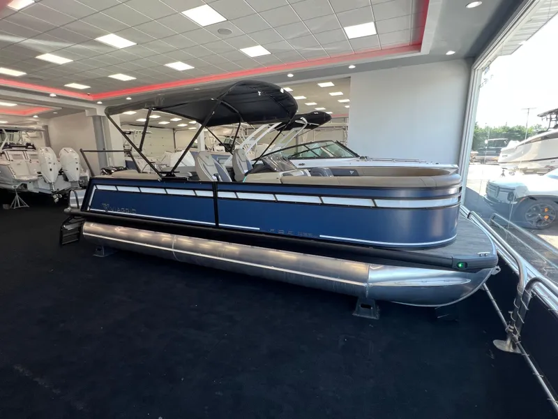 Slide: The Image of 2025 Viaggio Lago X-U pontoon boat displayed in showroom with modern interior. - 35