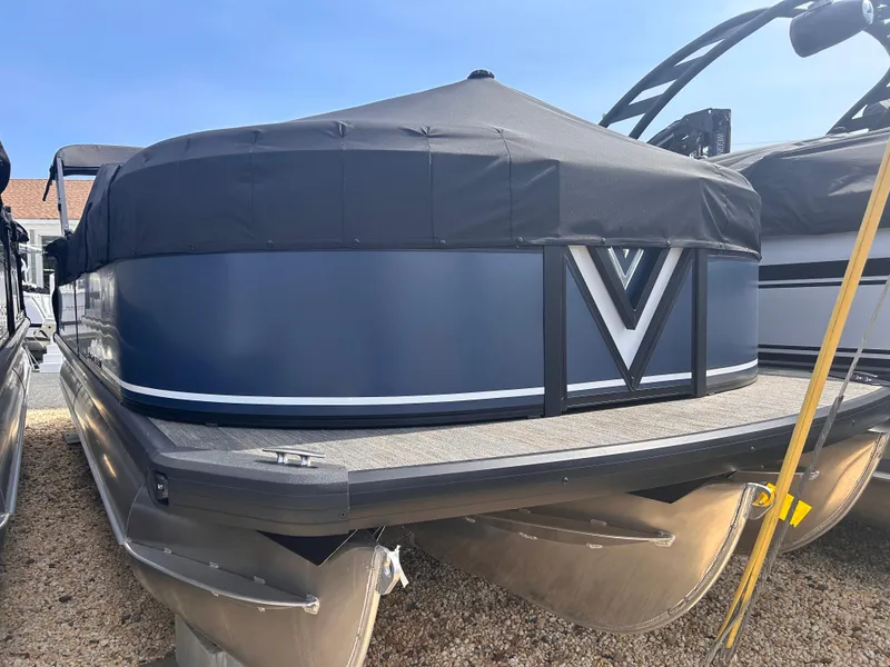 Slide: The Image of 2025 Viaggio Lago X-U pontoon boat with black cover, parked on gravel. - 4