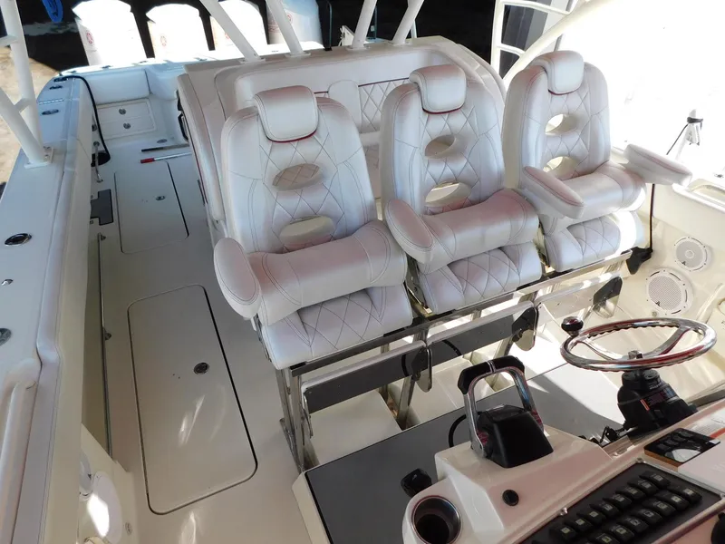 Slide: The Image of 2013 Hydra-Sports 4200 Siesta boat interior with luxurious white seating and modern controls. - 10