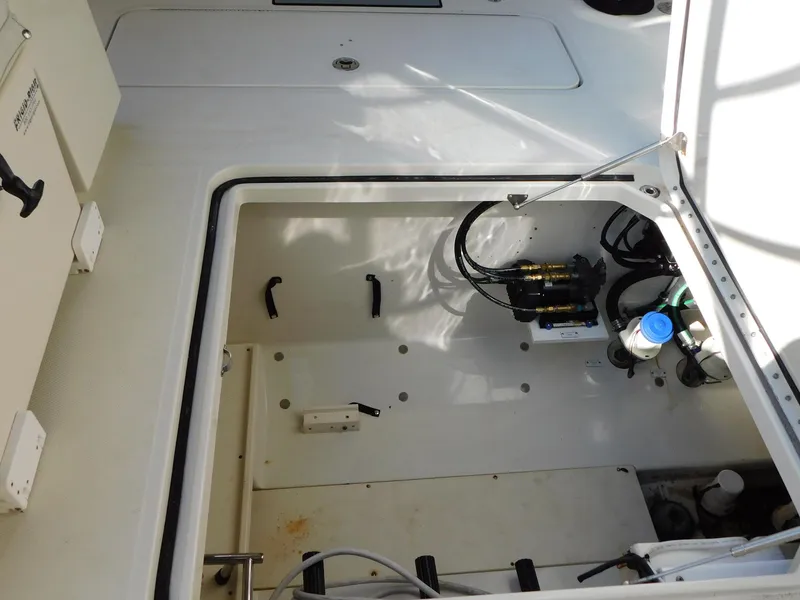 Slide: The Image of 2013 Hydra-Sports 4200 Siesta boat storage compartment with visible equipment and wiring. - 18