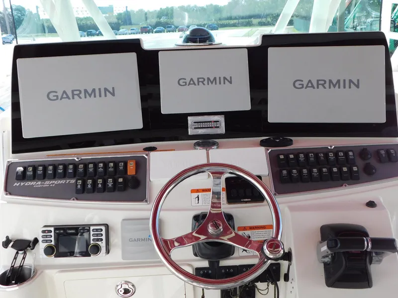 Slide: The Image of Control panel of 2013 Hydra-Sports 4200 Siesta with Garmin displays and steering wheel. - 9