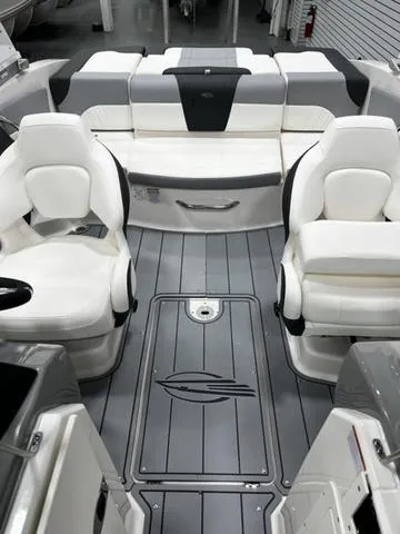 Slide: The Image of 2024 Chaparral 21 SSI Sport boat interior with white seating and gray flooring. - 8