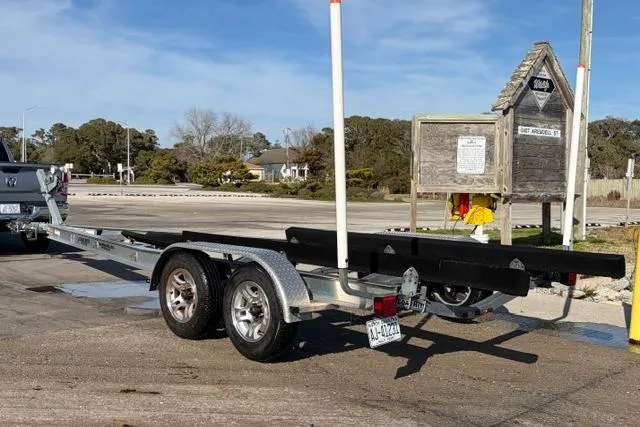 Slide: The Image of Trailer for 2019 Sportsman Masters 267 Bay Boat at a boat launch area. - 15
