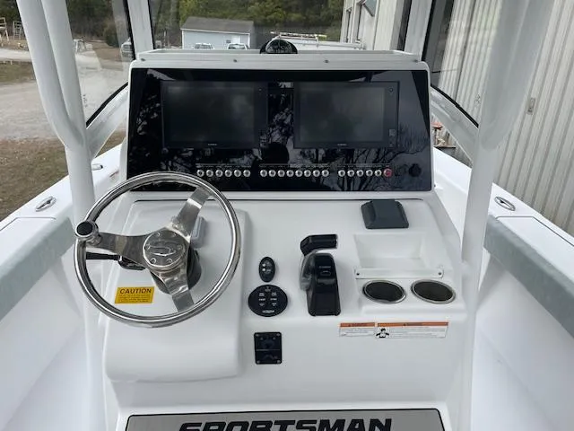 Slide: The Image of 2019 Sportsman Masters 267 Bay Boat docked, featuring dual seats and Yamaha engine. - 4