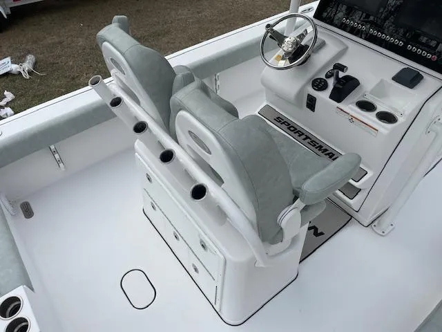 Slide: The Image of 2019 Sportsman 267 Masters boat, white interior, parked outdoors near trucks and trees. - 8