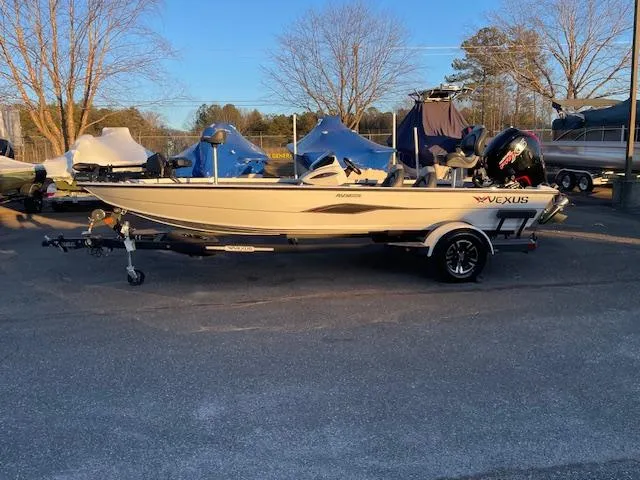 Slide: The Image of 2025 Vexus AVX V2 1880 boat on trailer in outdoor setting. - 1