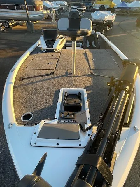 Slide: The Image of 2025 Vexus AVX V2 1880 boat deck with seating and equipment, in a marina setting. - 5